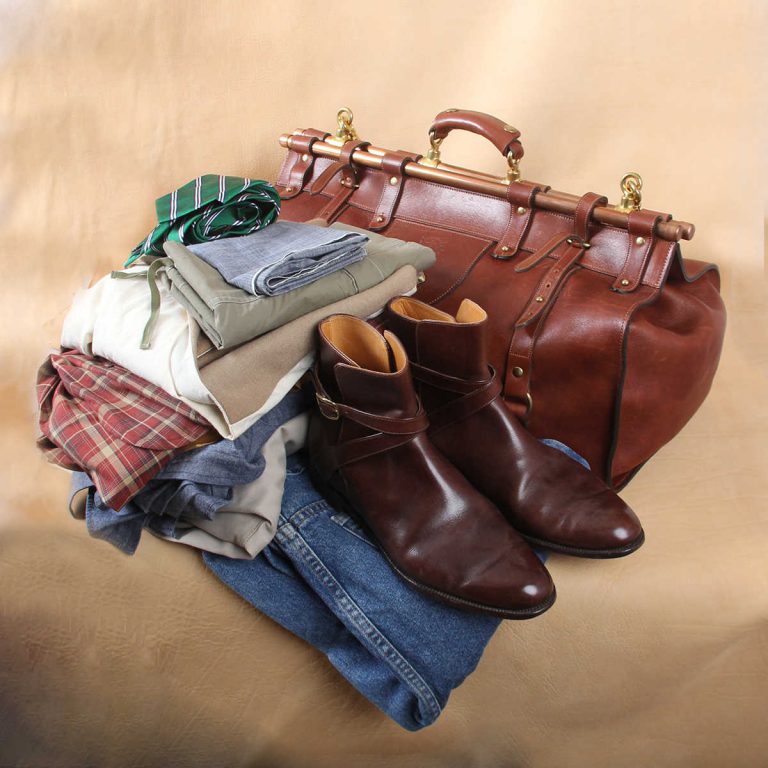 leather travel grip bag on table