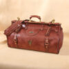 leather travel grip bag on table