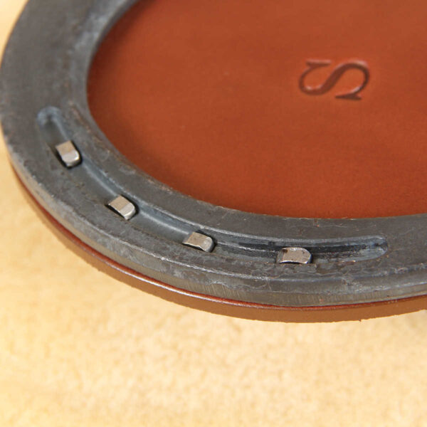 leather horseshoe coaster with horseshoe nails and bridle leather base