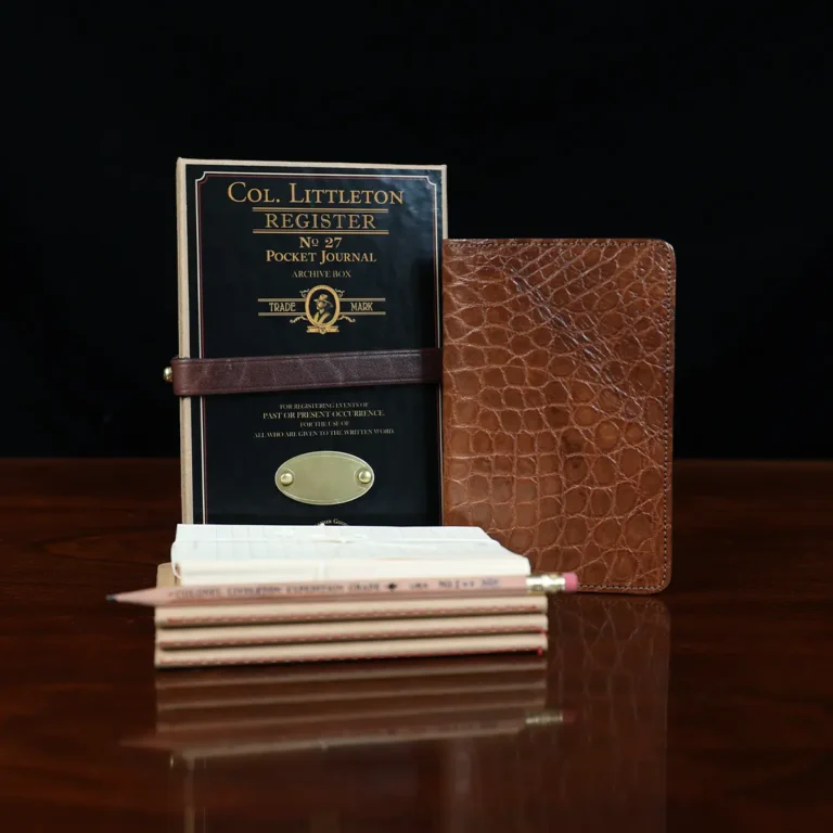 Group view of the no. 27 american alligator pocket journal with the refills, pencil, archive box and notecards included.