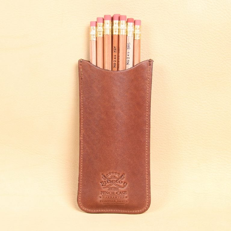 leather pencil case with pencils inside of pouch and product stamp