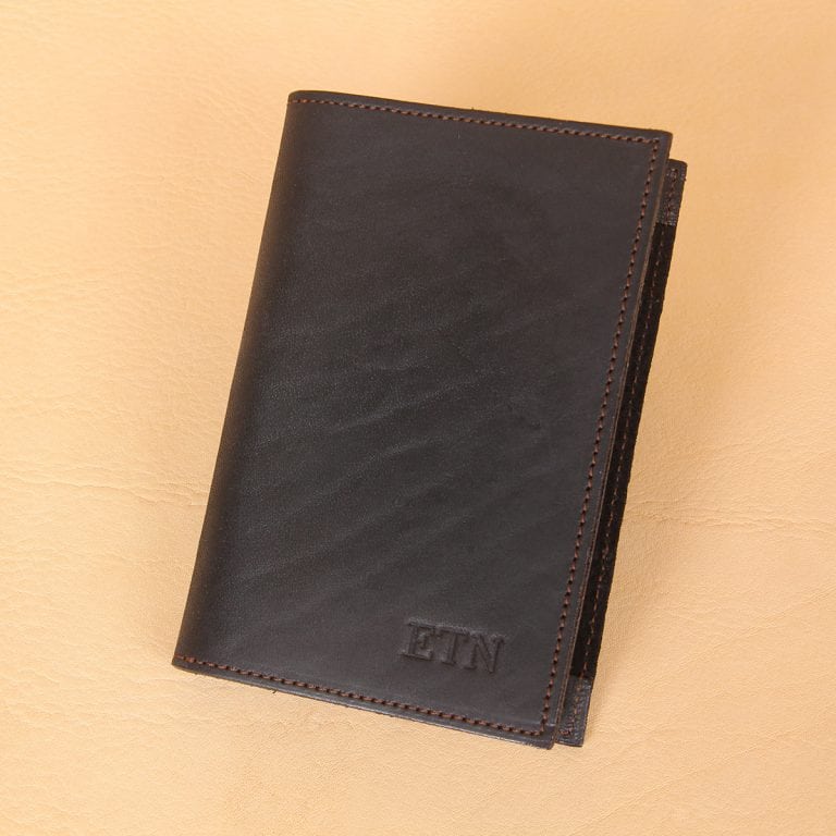 Pocket journal black leather front closed embossed with 3 initials in front right corner.