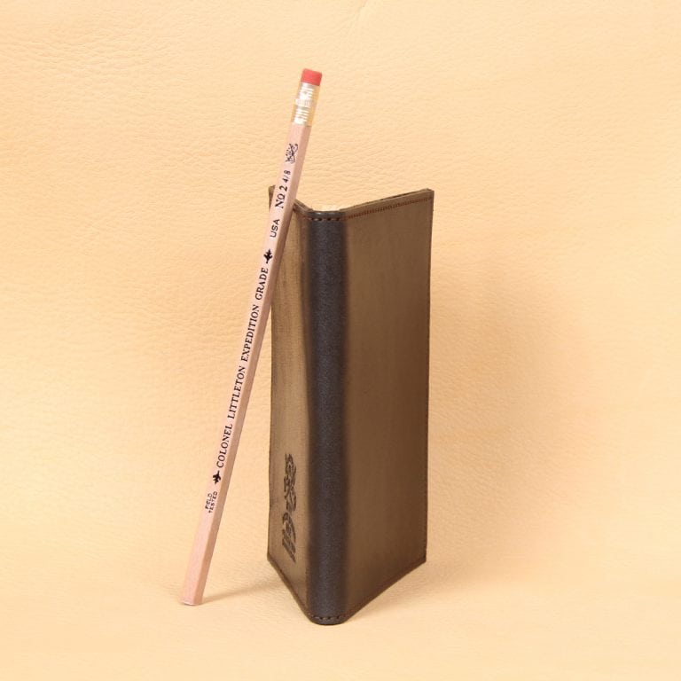 Pocket journal black leather spine and number 2 pencil.