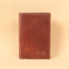 Pocket journal brown leather front embossed with 3 initials in lower right corner.