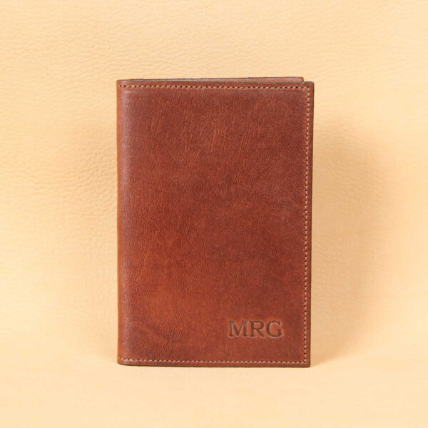 Pocket journal brown leather front embossed with 3 initials in lower right corner.