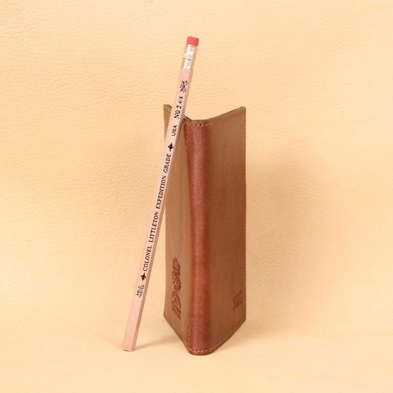 Pocket Journal brown leather side spine and number two pencil.