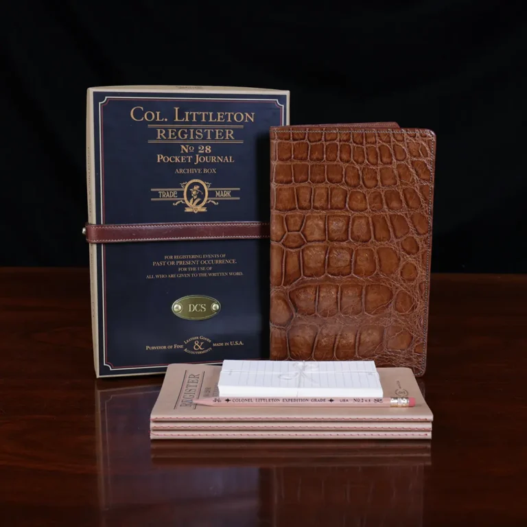 No. 28 Pocket Journal in Vintage Brown American Alligator - ID 001 - front view, shown with journal register archive box, 3 journal register notebooks, a stack of cream index notecards, and a Col. Littleton wooden No. 2 pencil - on black background