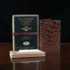 No. 28 Pocket Journal in Vintage Brown American Alligator - ID 002 - front view, shown with journal register archive box, 2 journal register notebooks, a stack of cream index notecards, and a Col. Littleton wooden No. 2 pencil - on black background