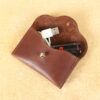 no15 vintage brown american leather pouch with contents spilling out