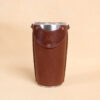 Leather tumbler sleeve for 20 ounce Yeti Rambler cup front sitting on table.