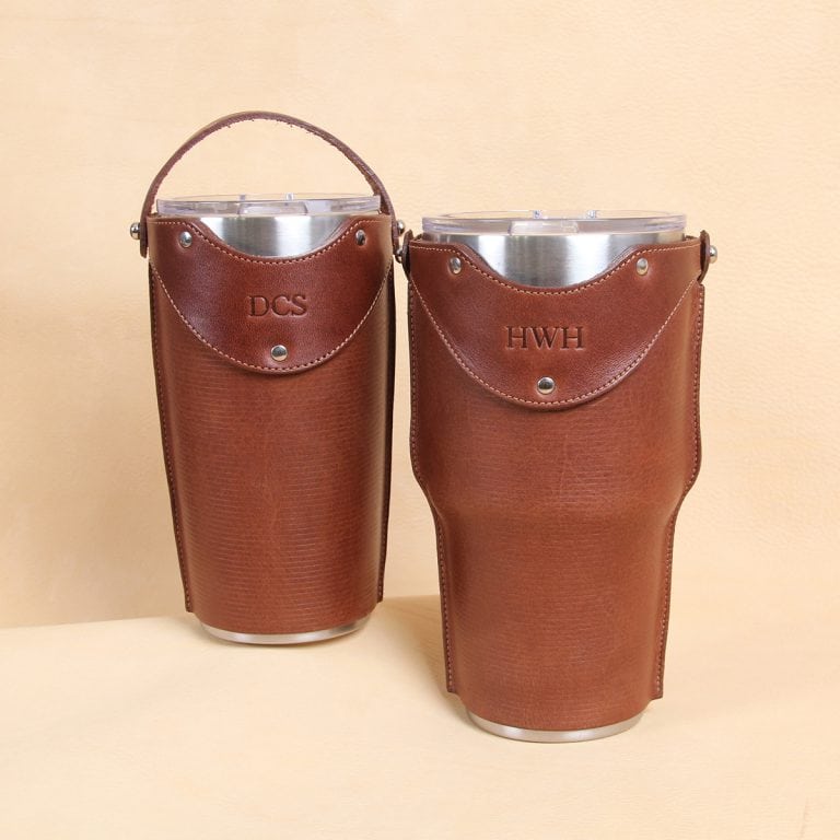 Leather tumbler sleeve for 20 and 30 ounce Yeti Rambler cups in brown sleeve front sitting on table.