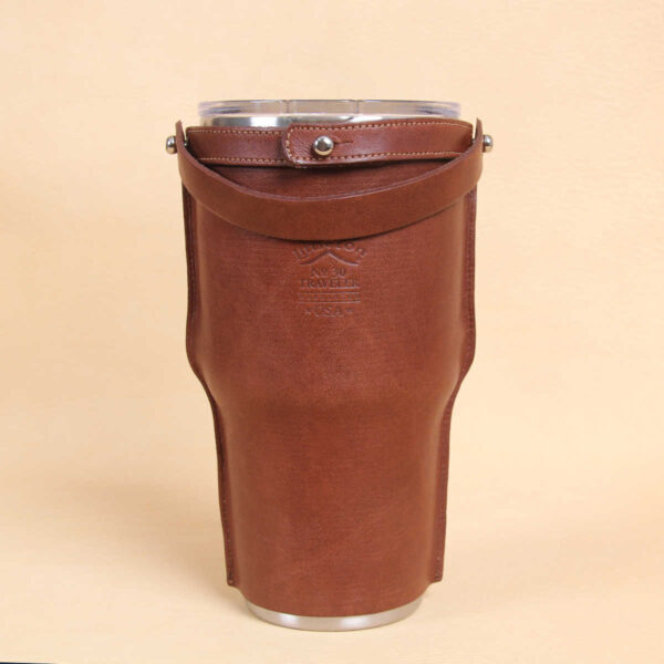 Leather tumbler sleeve for 30 ounce Yeti Rambler cup back side with carrying handle laid back.