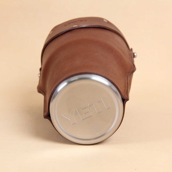 Leather tumbler sleeve for 30 ounce Yeti Rambler cup bottom of stainless steel cup Yeti logo.