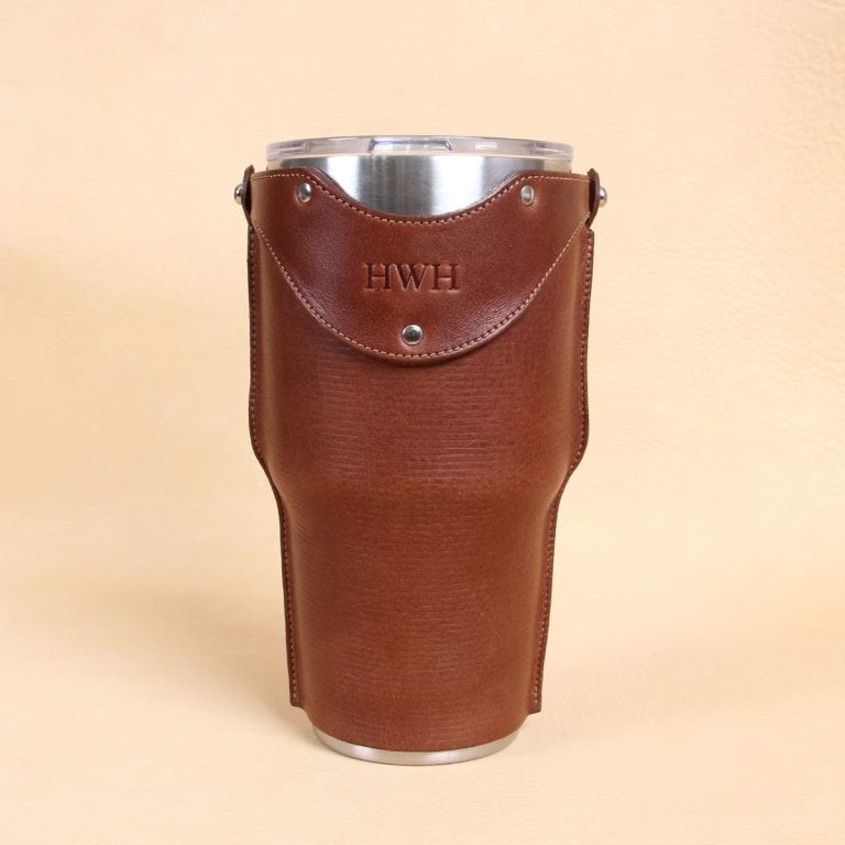 Leather tumbler sleeve for 30 ounce Yeti Rambler cup front sitting on table.