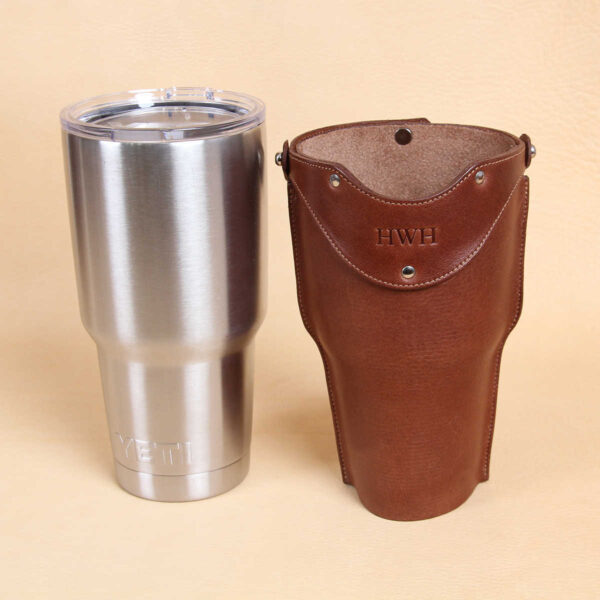 Leather tumbler sleeve for 30 ounce Yeti Rambler cup and brown leather sleeve side by side.