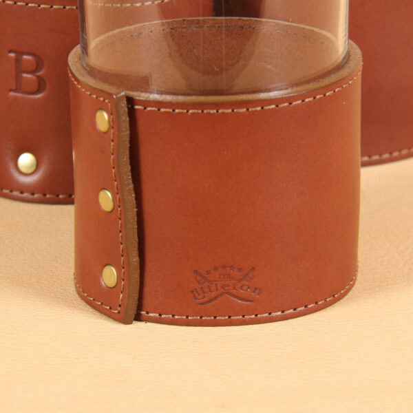 brown leather glass sleeve with product stamp