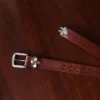 no1 brown leather belt with nickel hardware - hook view - on a wooden table