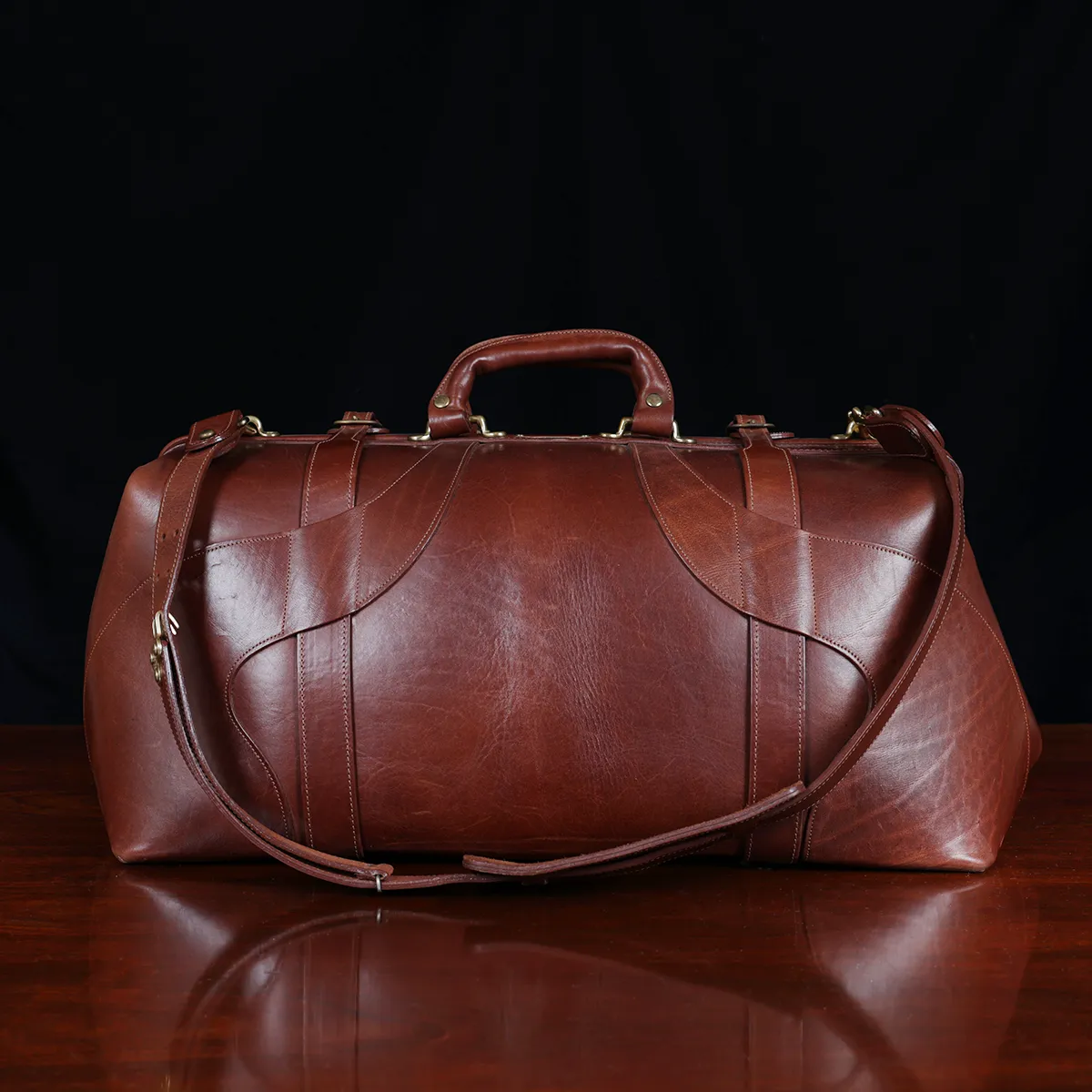No. 5 Grip in Vintage Brown Steerhide - back view- on a wood table with a dark background