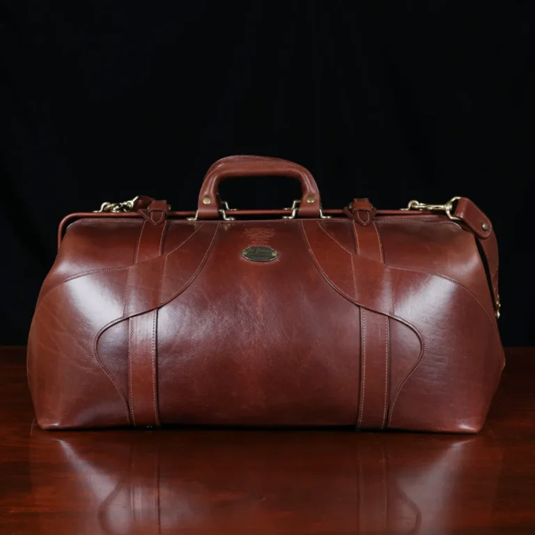 No. 5 Grip in Vintage Brown Steerhide - front view- on a wood table with a dark background