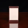 no1 vintage brown leather note card case with notes on wooden table - front view