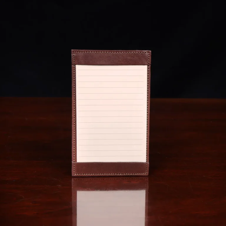 no1 vintage brown leather note card case with notes on wooden table - front view