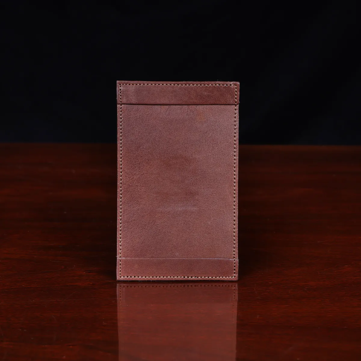 no1 vintage brown leather note card case on a wooden table