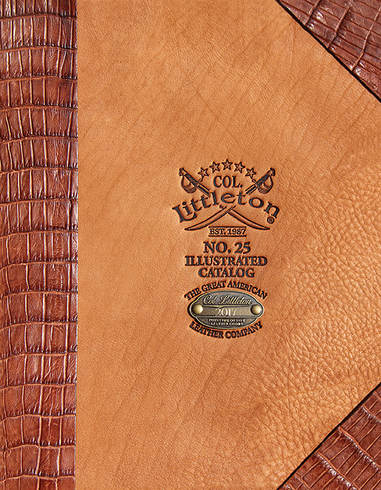 The 2017 Colonel Littleton Catalog cover, made of a saddletan hide stamped with the logo and trimmed with alligator along the spine and in two corner.