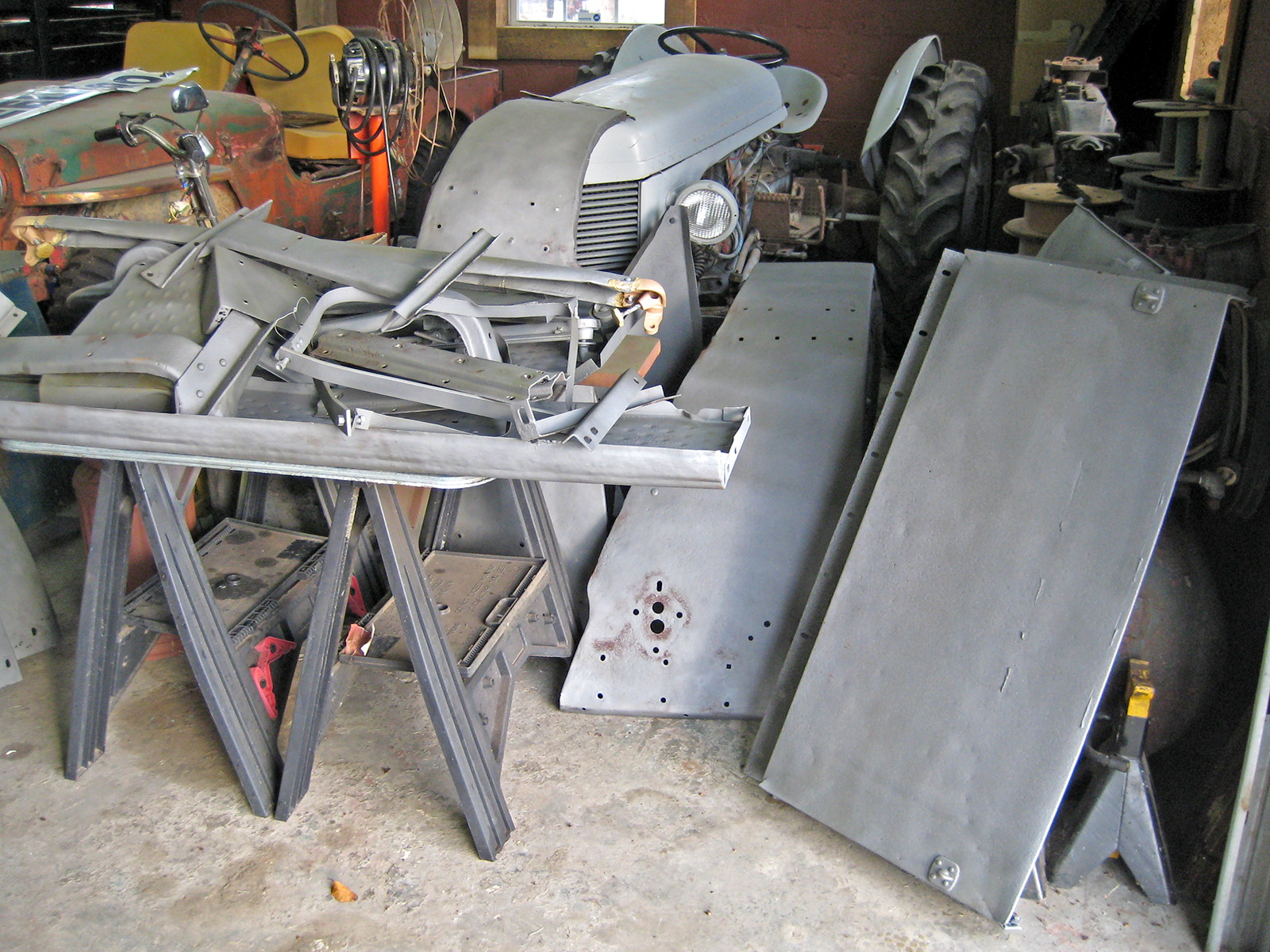 Miscellaneous sandblasted body pieces of a 1941 Army Command Car.
