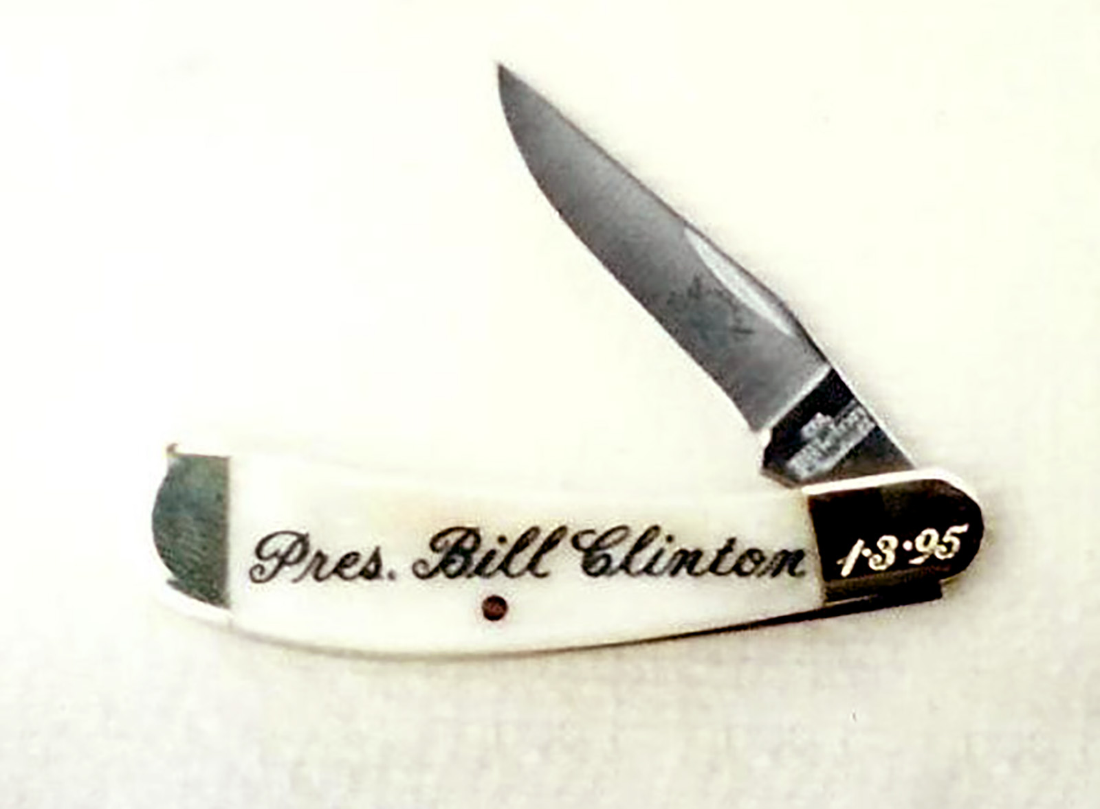 White bone handled Colonel Littleton knife with nickel bolsters, engraved with Pres. Bill Clinton and the date 1-3-95