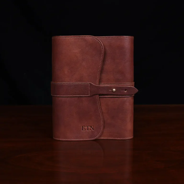 no9 brown american leather journal with notepad on wood table with dark background