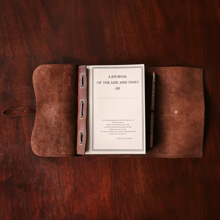 no9 brown american leather journal with notepad on wood table with dark background - open view