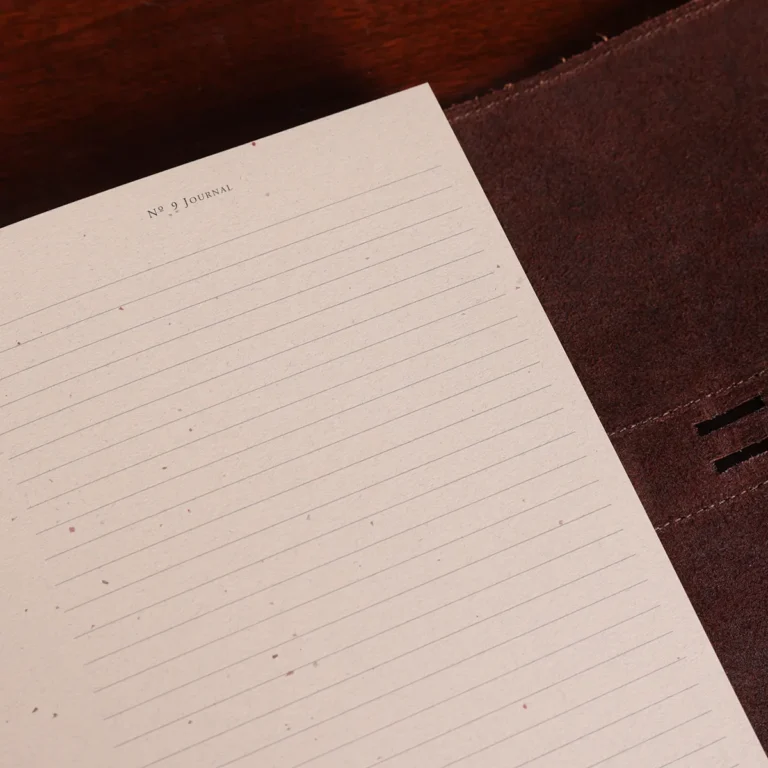 no9 brown american leather journal with notepad on wood table- ruled paper