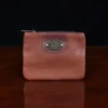 no1 brown leather small zip it bag - front view - on wooden table