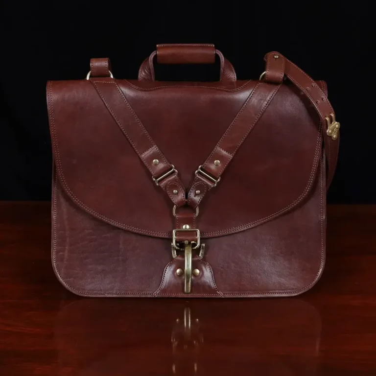 commander leather laptop briefcase on a wooden table with a dark background - front view