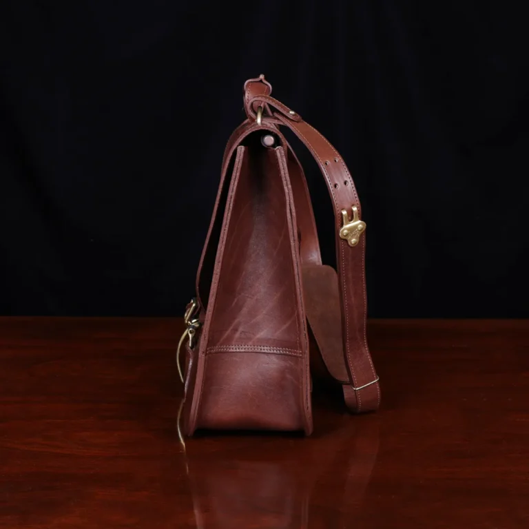 commander leather laptop briefcase on a wooden table with a dark background - side view