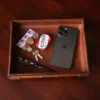 No. 120 Valet Tray on wooden table holding phone, keys, mints, stamps, change, and pen
