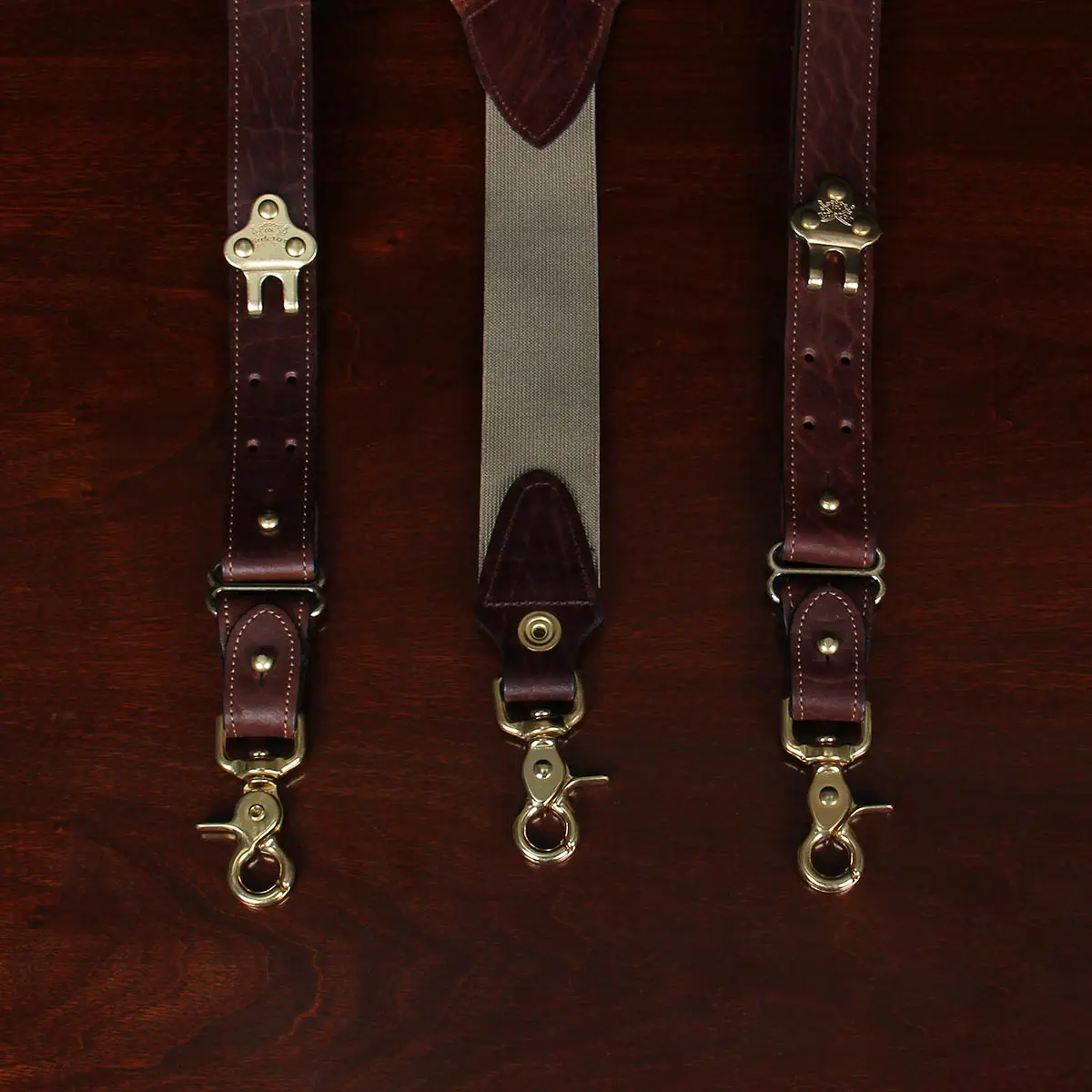 closeup view tobacco brown american buffalo leather suspenders and brass hardware