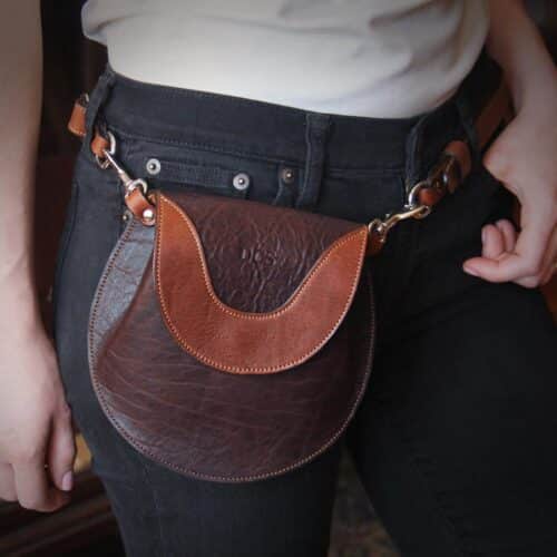 Bitsy Belt Bag in dark Tobacco Brown American Buffalo - woman in black jeans and white shirt wearing the purse around her waist