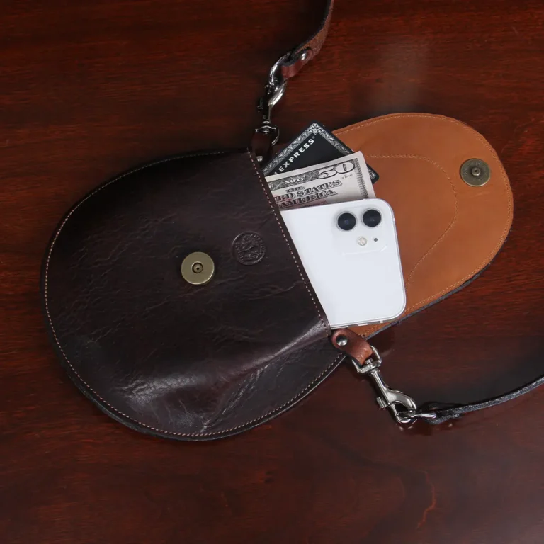 Bitsy Belt Bag in dark Tobacco Brown American Buffalo - open view with a phone, $50 bill, and black American Express card