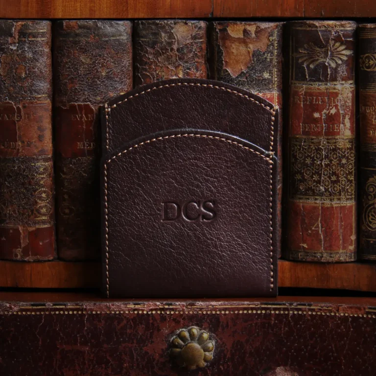 tobacco american buffalo leather front pocket wallet with initial personalization in front of vintage books