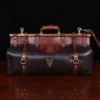 Front view of Dark brown buffalo leather No. 3 grip travel bag sitting on table