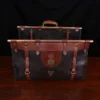 Open front view of Dark brown buffalo leather No. 3 grip travel bag sitting on table