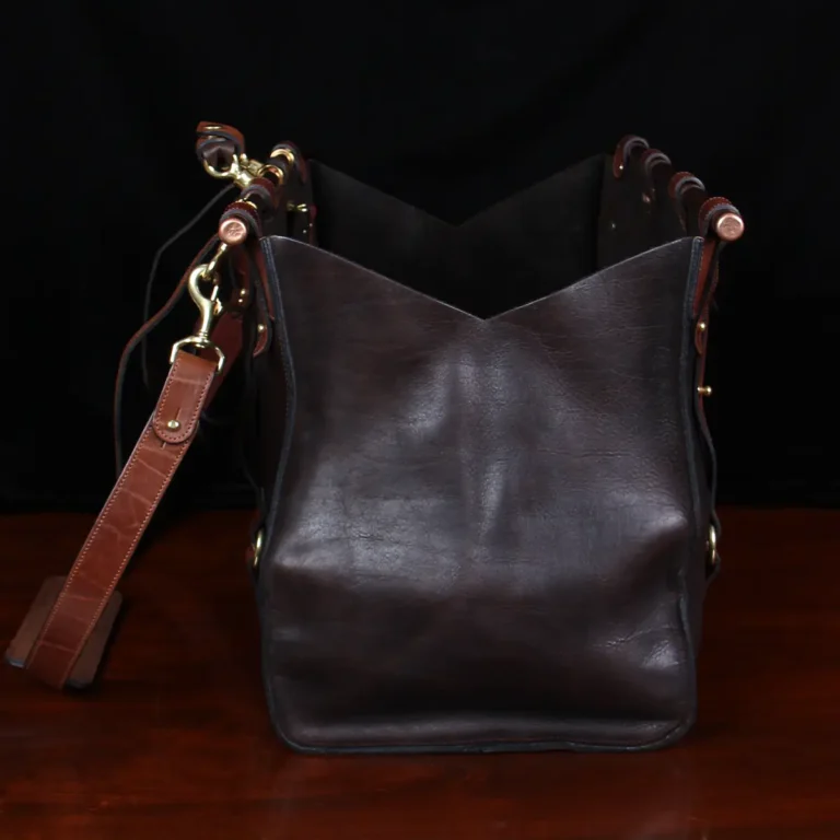 Side and open view of Dark brown buffalo leather No. 3 grip travel bag sitting on table