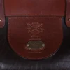Dark brown buffalo leather No. 3 grip travel bag close-up of logo stamp and plate