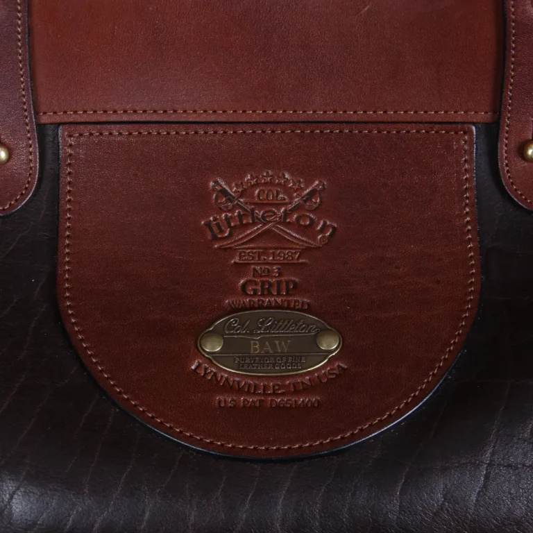Dark brown buffalo leather No. 3 grip travel bag close-up of logo stamp and plate