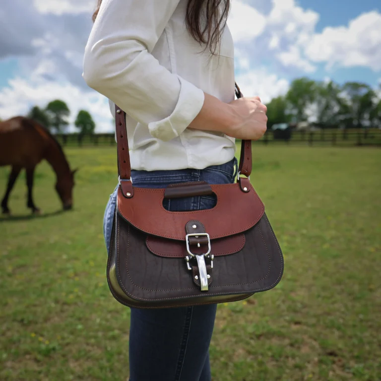 No. 17 Hunt Bag made of two-tone brown American Buffalo and Vintage Brown Steerhide leather worn crossbody on woman