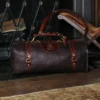 No. 1 Duffel Bag in Tobacco Brown American Buffalo - Front view of back on the floor in front of a fireplace