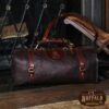 No. 1 Duffel Bag in Tobacco Brown American Buffalo - Front view of back on the floor in front of a fireplace