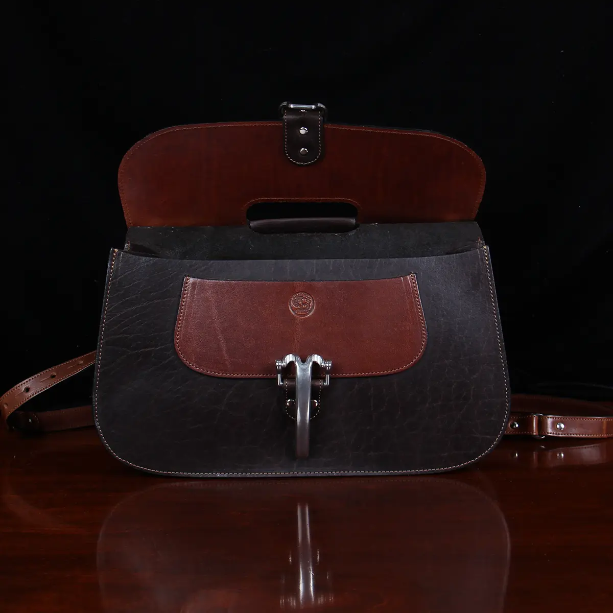 no 18 leather huntbag in tobacco buffalo - front open view - on a wood table with dark background