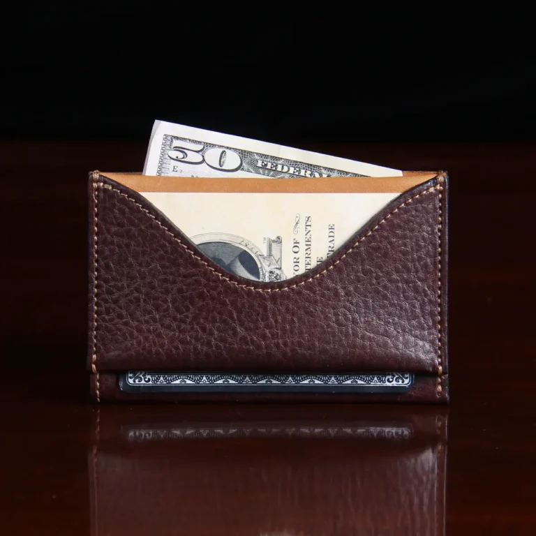 no33 tobacco brown american buffalo in - front view - with money and card on wood table with dark background